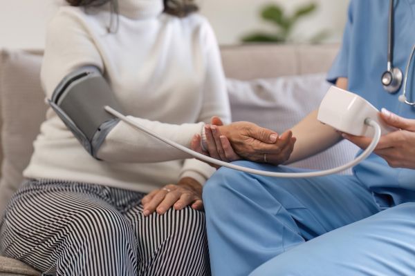 A nurse monitoring the patients cholesterol