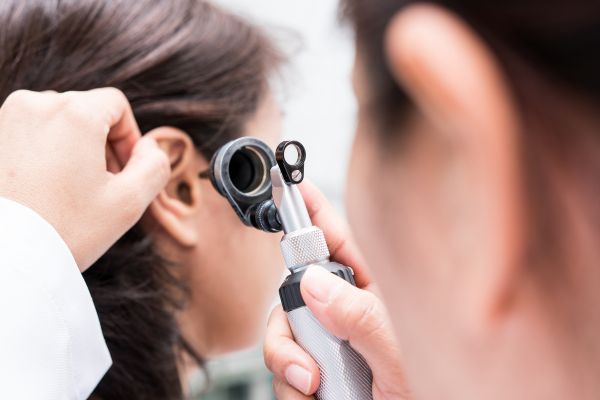 A doctor is examining the patient's neck.


