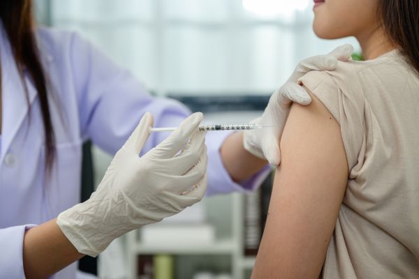 A doctor is examining the patient's neck.


