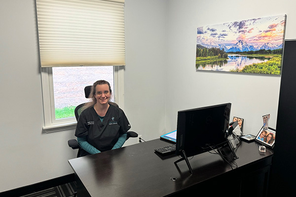 A female Physician Assistant is seated in her office.


